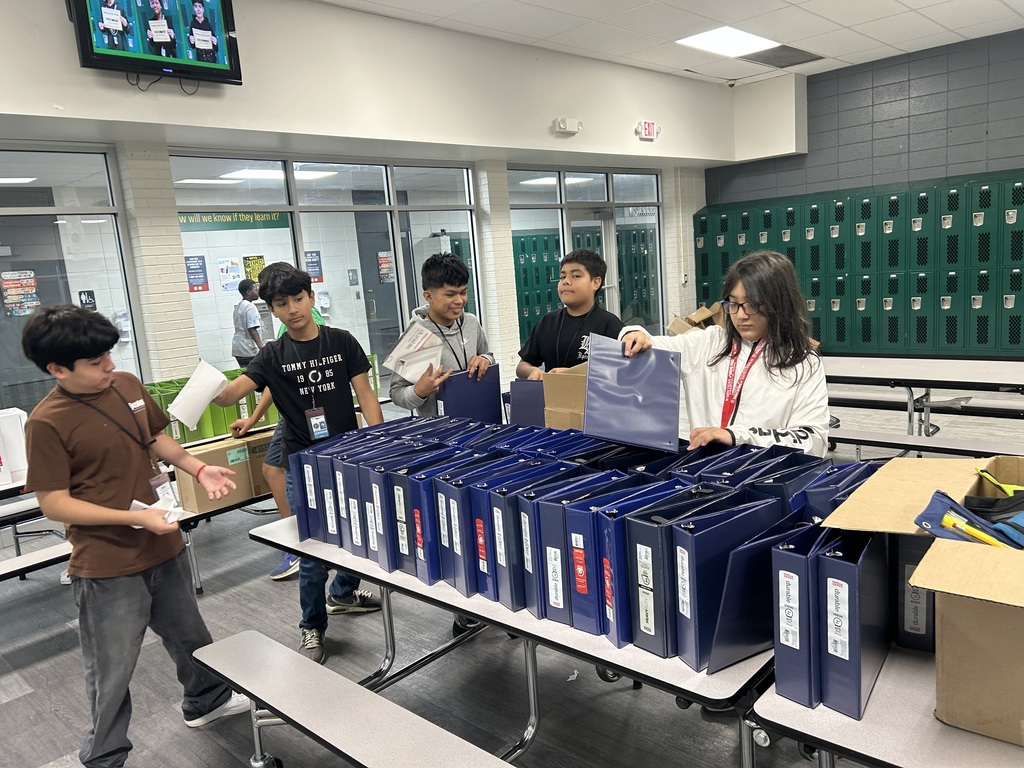 Pic of AVID/AVID Excel scholars setting up binders for school wide launch
