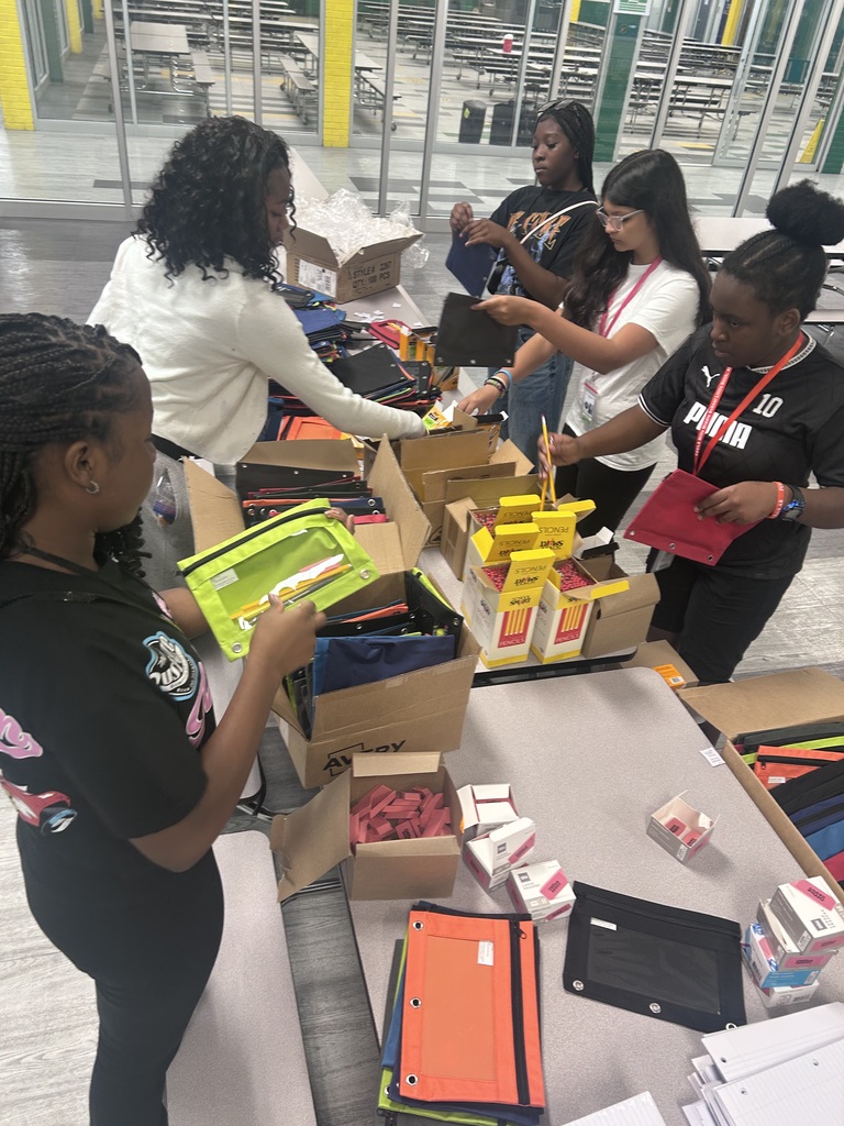 Pic of AVID/AVID Excel scholars setting up binders for school wide launch