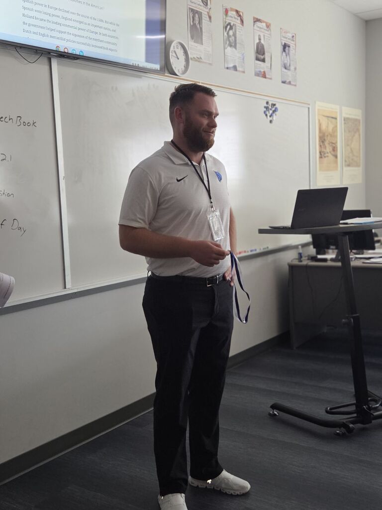 Coach Briggs receives the "I Build Champions" award for August 2026.  
