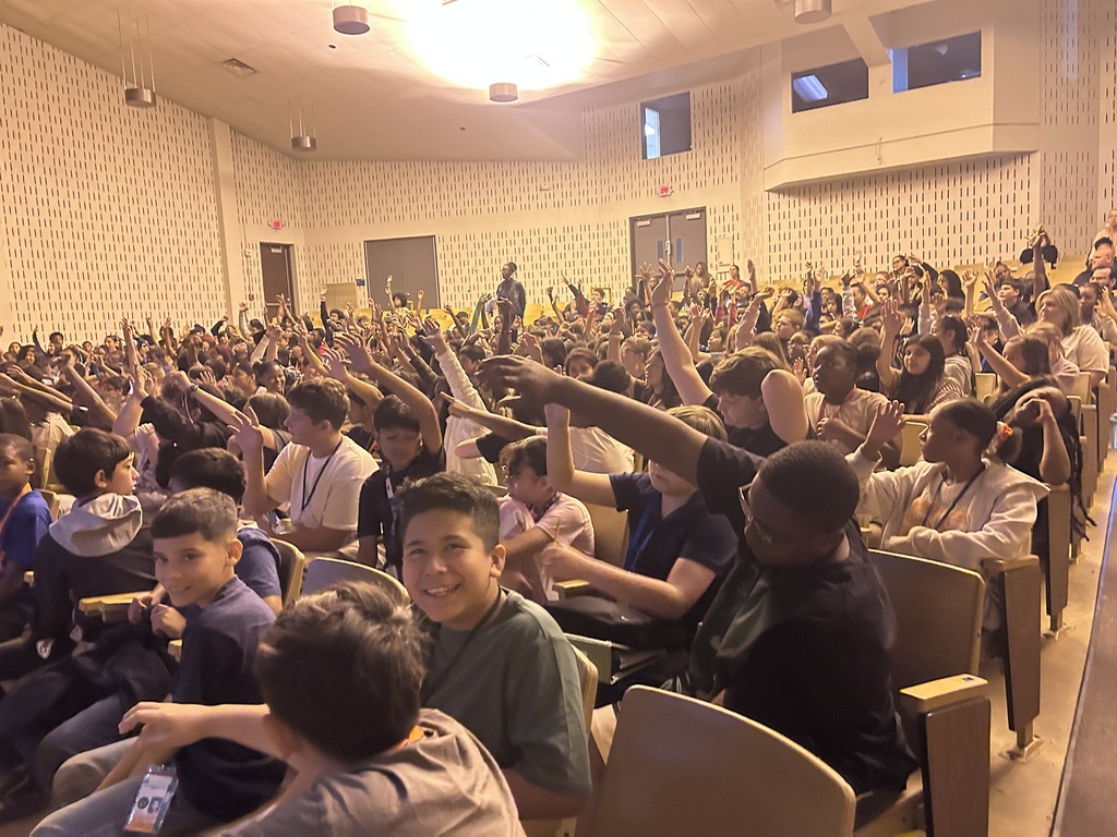 MMS Scholars enthusiastically waving their hands for Kyle Greene