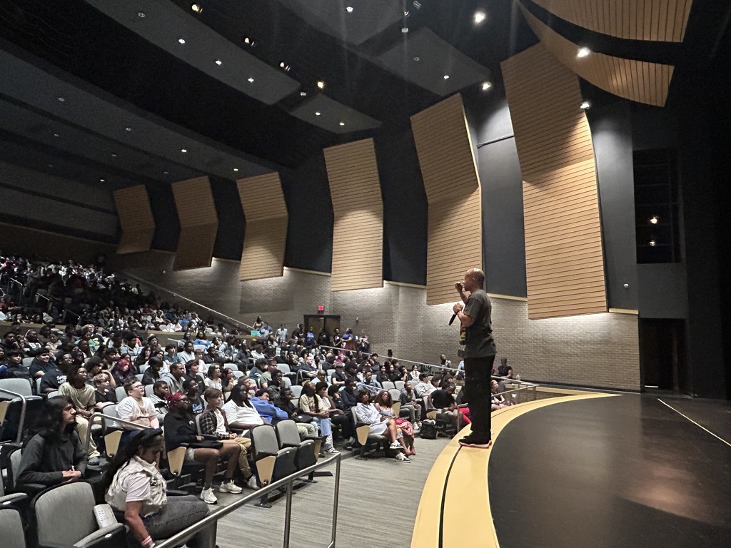 Guest Speaker in front of an auditorium full of students