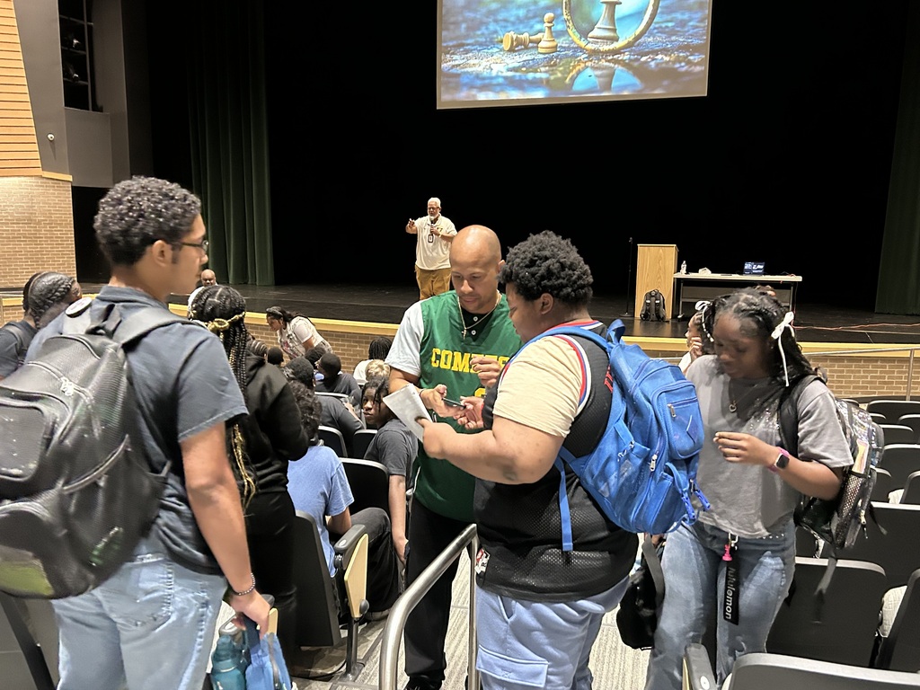 Students asking guest speaker for an autograph