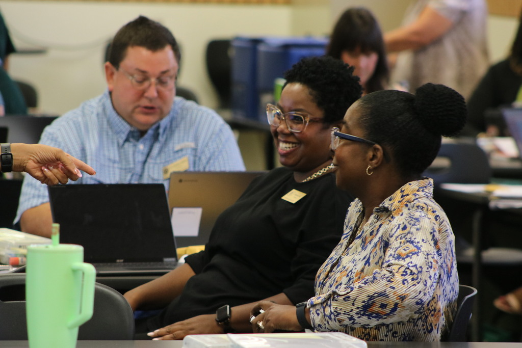 Principals smiling in a meeting