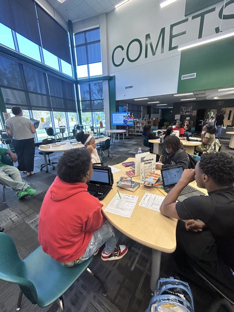 Students in the library listening to discussions about book genres