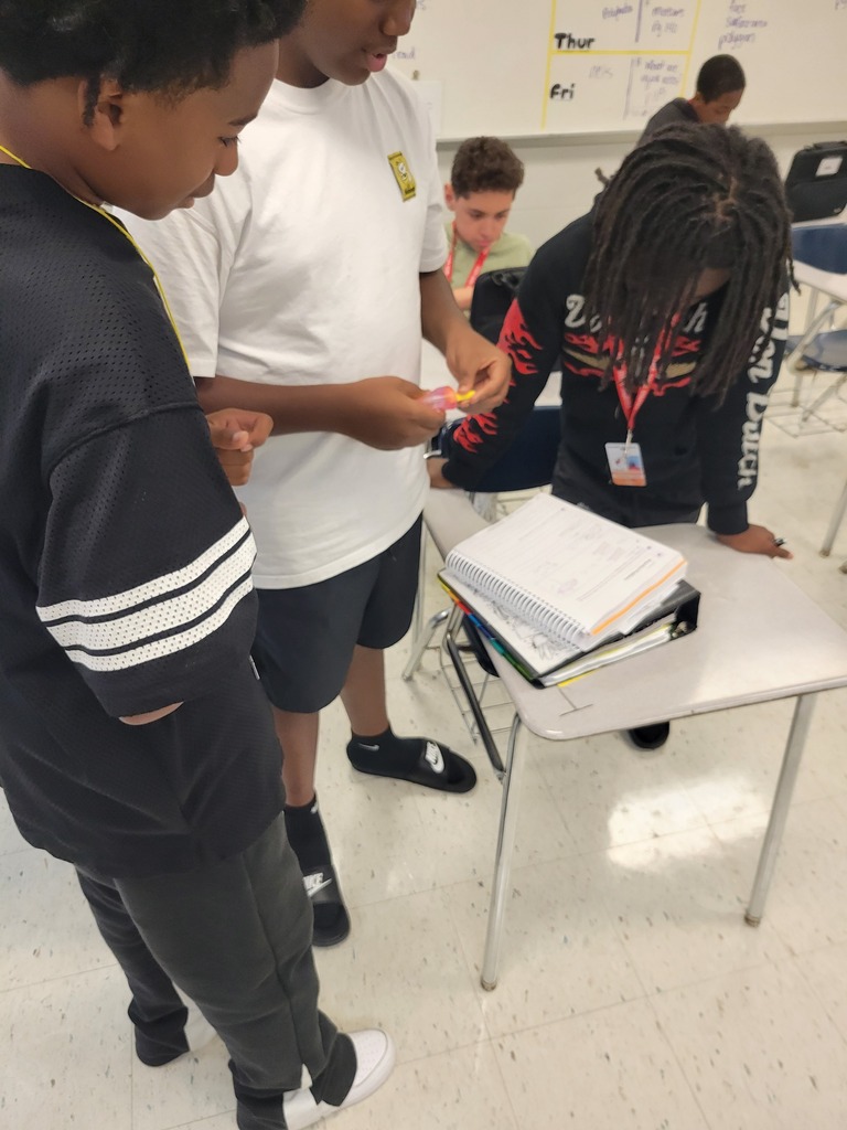 football players helping with student work