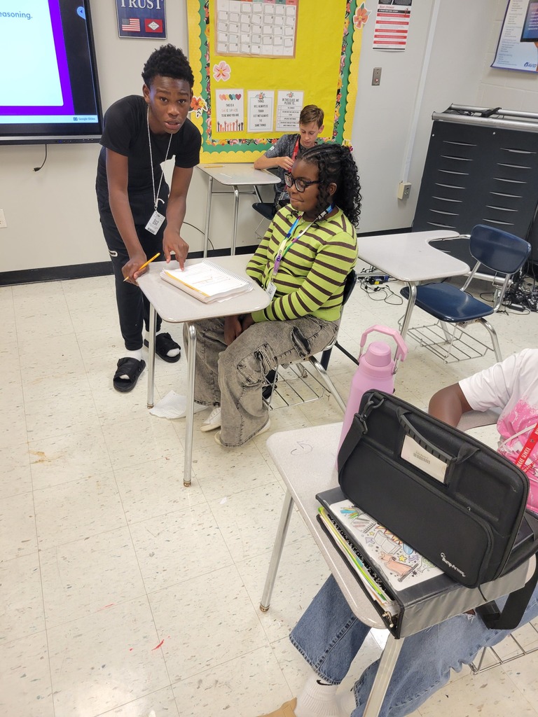 football players helping with student work2