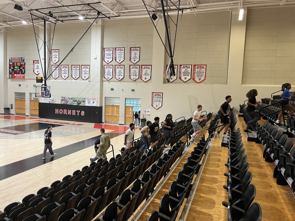 Students climbing up steps in a "Hornets" auditorium