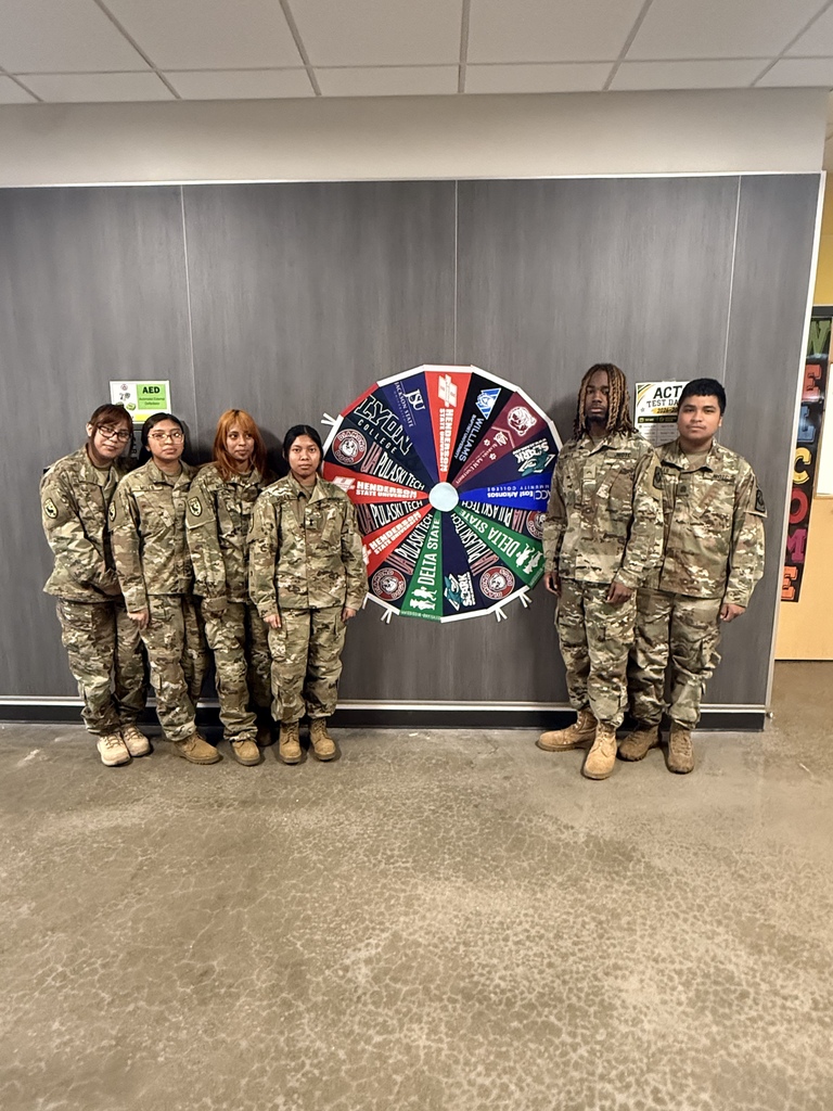 JROTC students in their fatigues in front of college banners