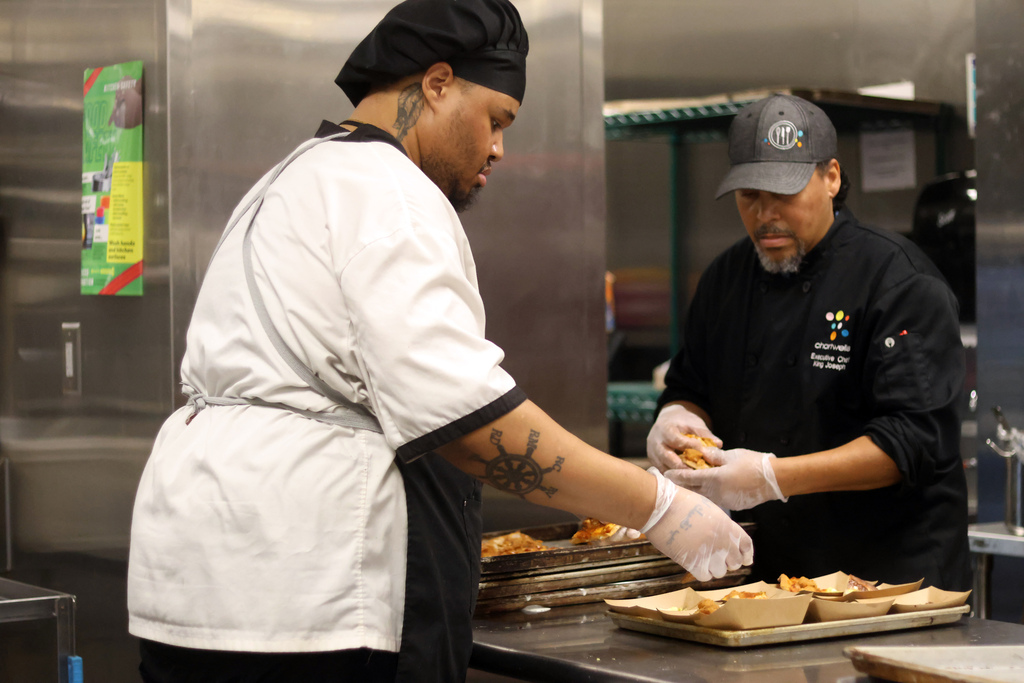 Chef Green and Chef King prepare food in a school cafeteria