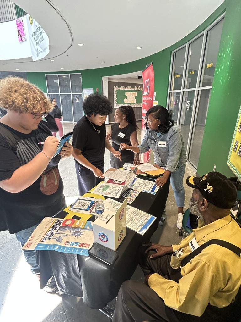 Students are around the voter registration table