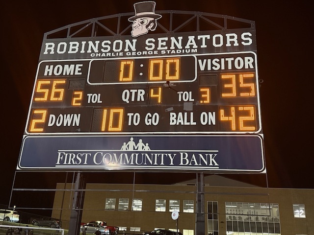 Nighttime shot of the Charlie George Stadium scoreboard displaying a final score of Home 56, Visitor 35, with zero time remaining in the fourth quarter under the Robinson Senators mascot logo.