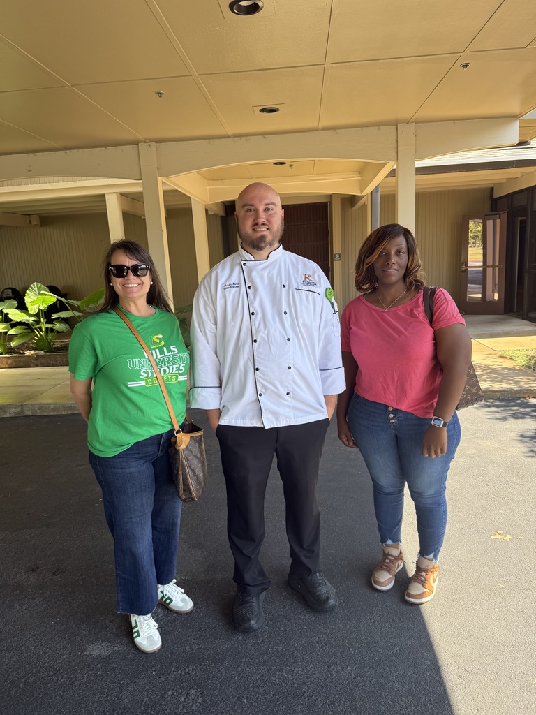 Two teachers standing with the Chef