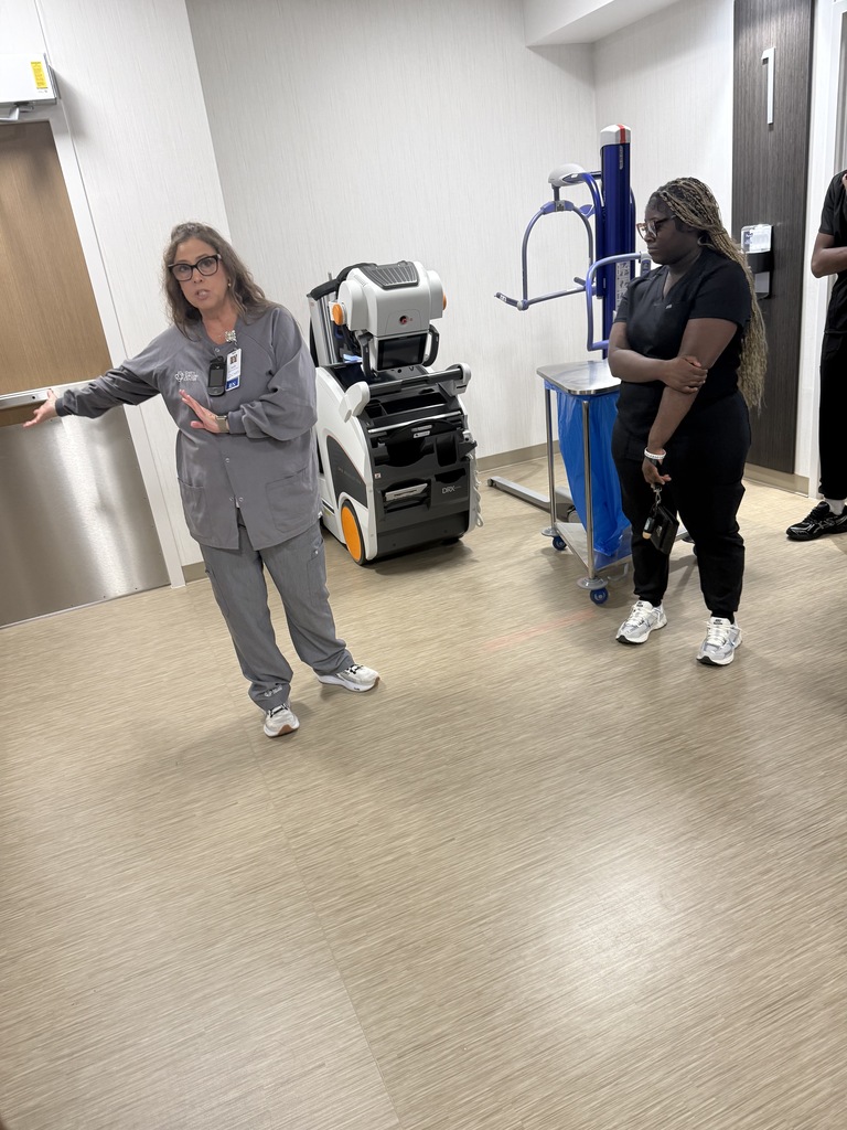 Student listening to lead nurse explain their industry tour