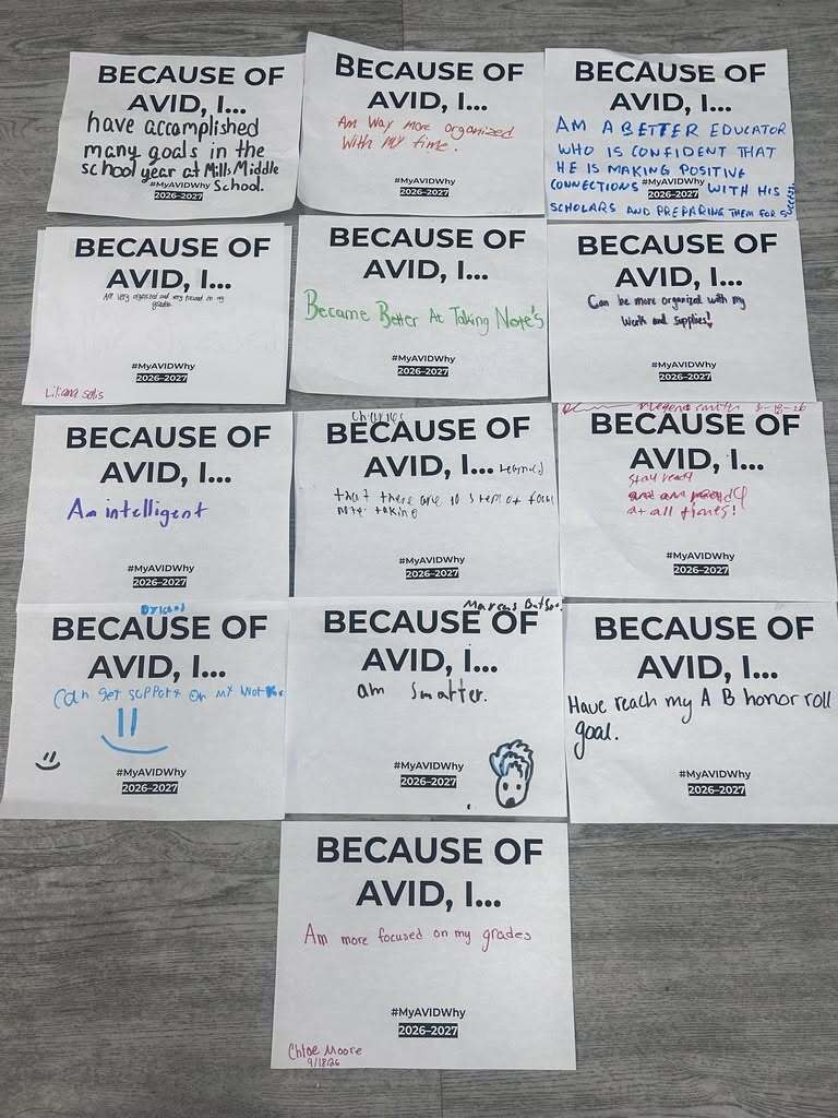 A collection of "Because of AVID, I..." reflection sheets is arranged on a tabletop. The handwritten responses from students and staff describe how AVID has helped with note-taking, goal setting, academic achievement, confidence, organization, and staying focused on grades. Each sheet features the #MyAVIDWhy message and reflects personal growth through AVID.