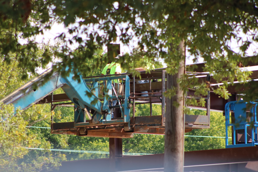 A shot of College Station Elementary construction showing a man lifted high by heavy machinery