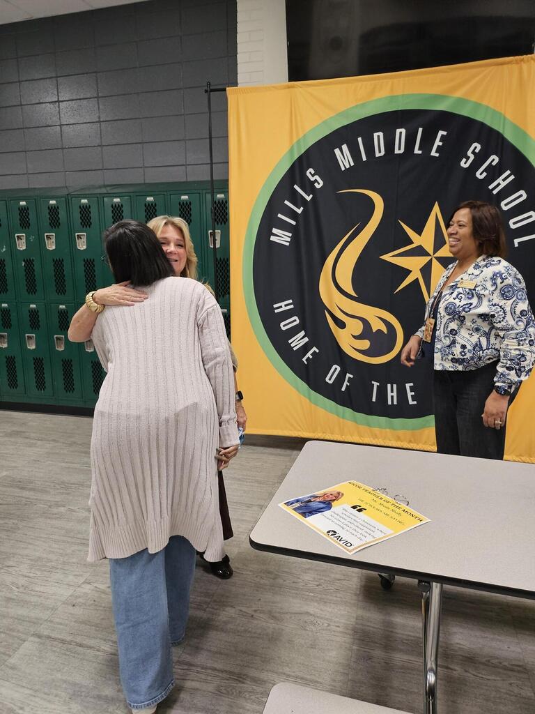 Ms. Shelly congratulated by counselor for winning WICOR Teacher of month