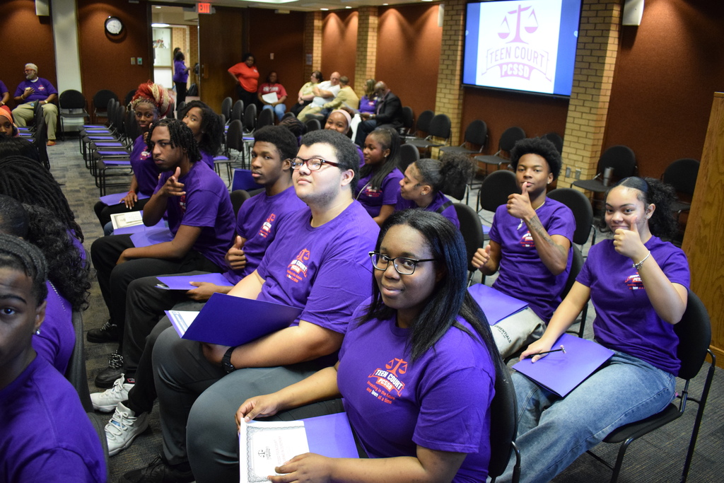Students sit in rows looking toward the camera
