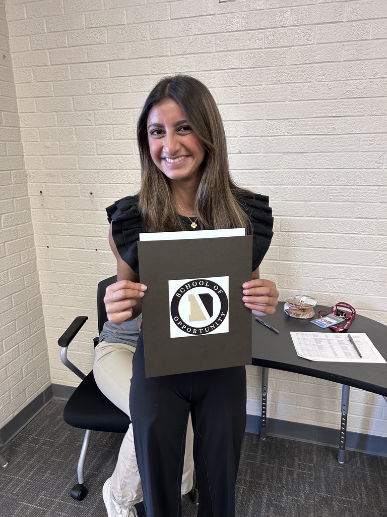 A student holds a DRIVEN School of Opportunity folder