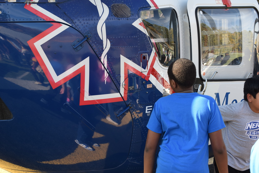 A student admires a medflight helicopter
