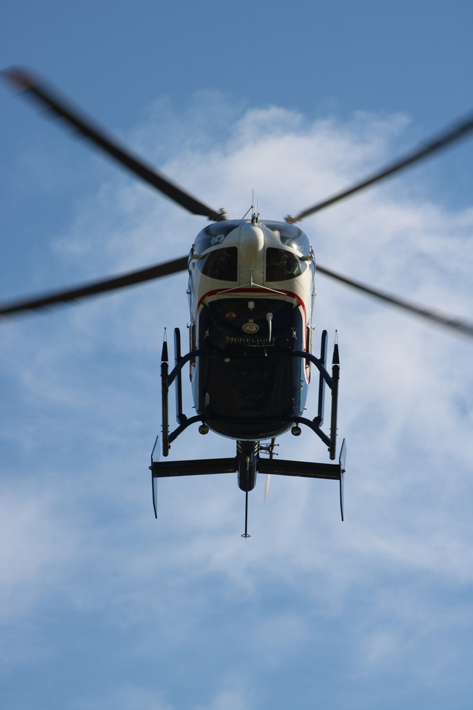 A helicopter descends from above