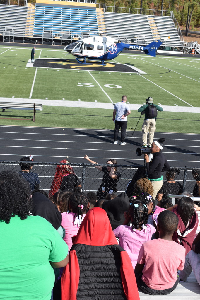 Students look on a medical helicopter