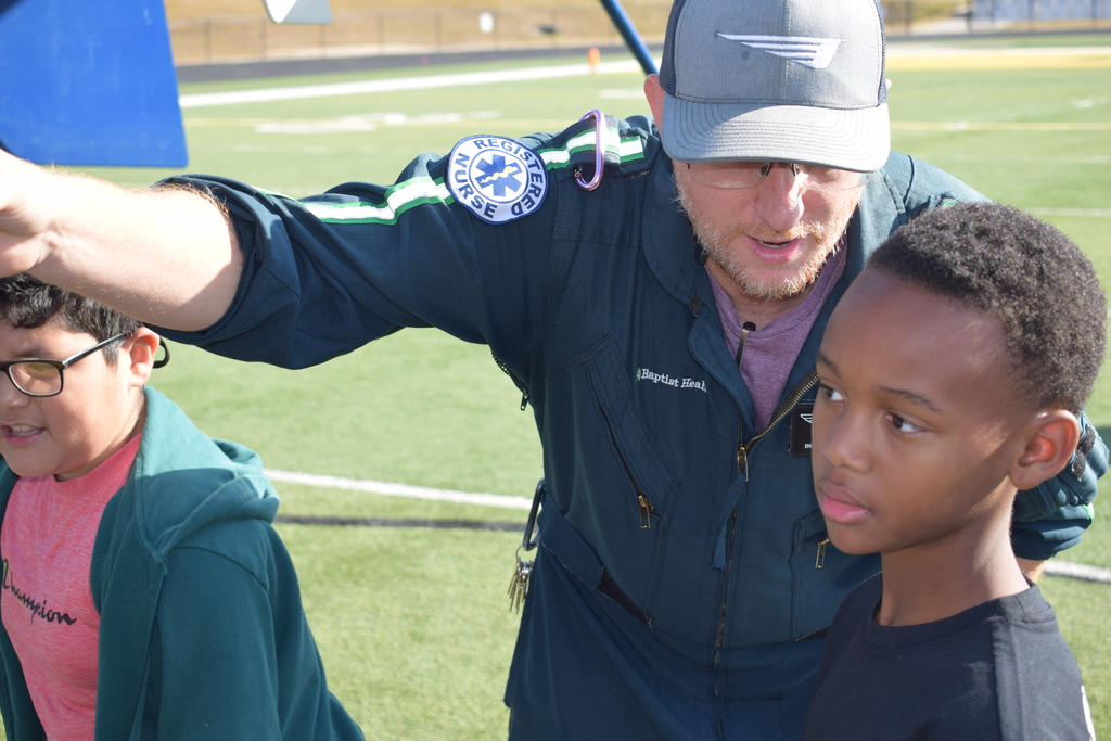 A student listens to a helicopter paramedics answer to a question