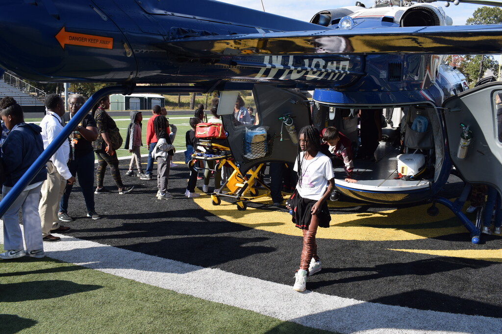 A student walks out the back of a MedFlight helicopter