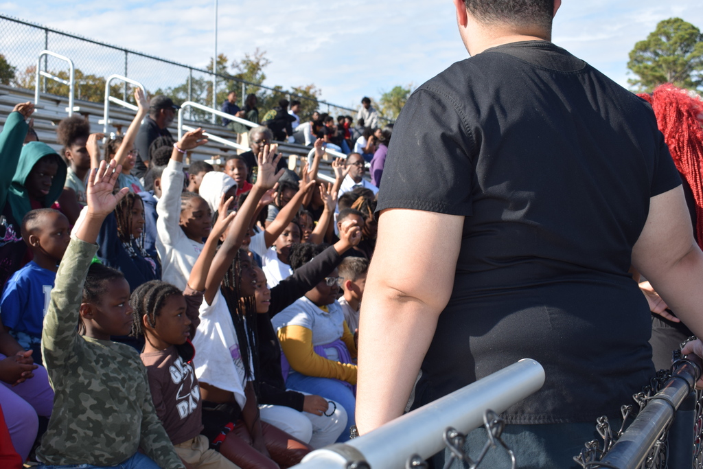 Students raise their hands to ask questions