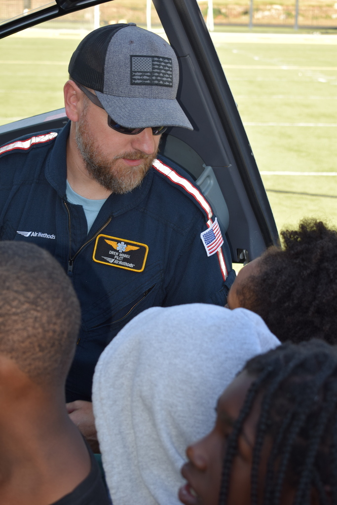 A student asks a helicopter paramedic a question