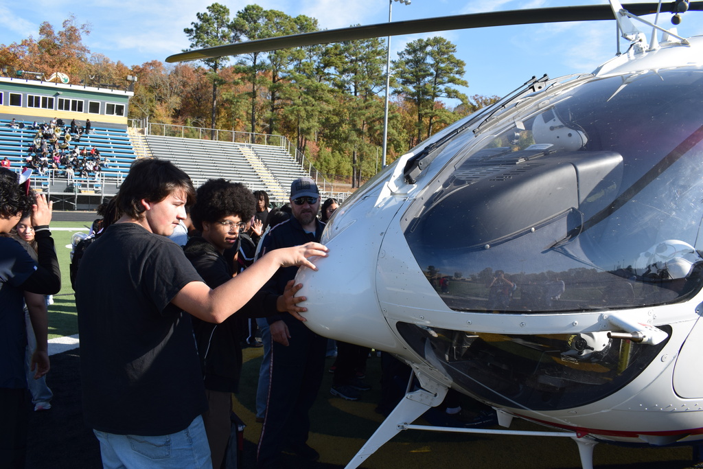 A student has a hands on experience with a helicopter