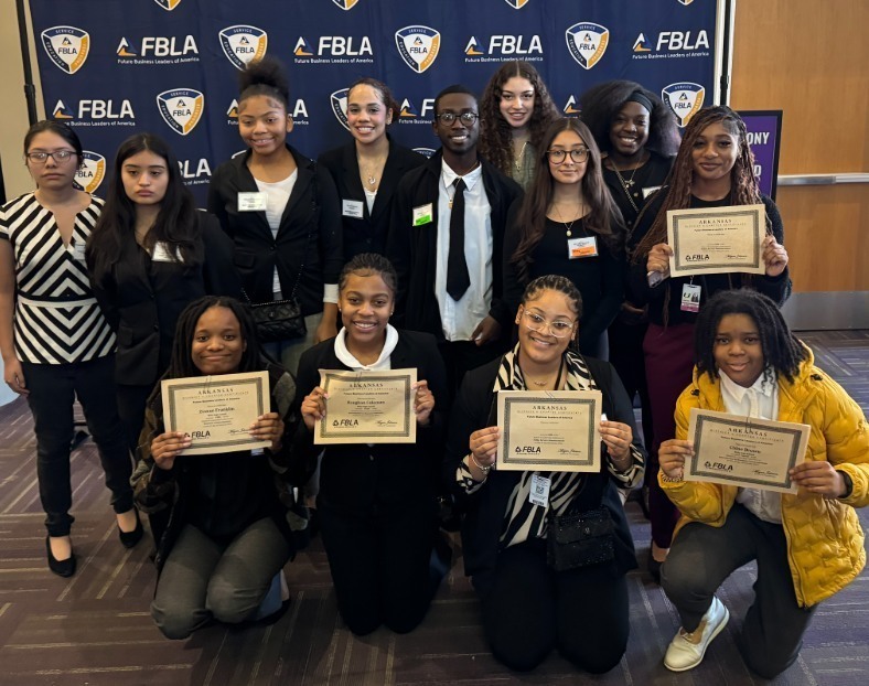multiple FBLA students posing together. Some  hold certificates.