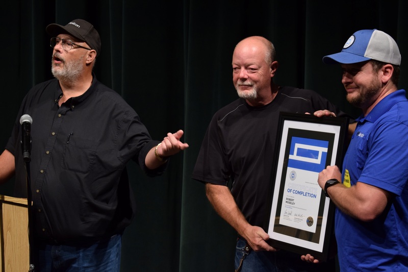 Welding instructor Robert Moseley receives certificate