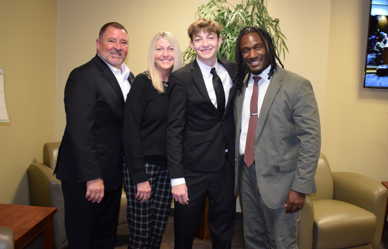 OCTOBER 2025 STUDENT BOARD MEMBER Liam French, his parents, and Maumelle High School Principal Dr. Farr. They are shoulder to shoulder smiling for a picture