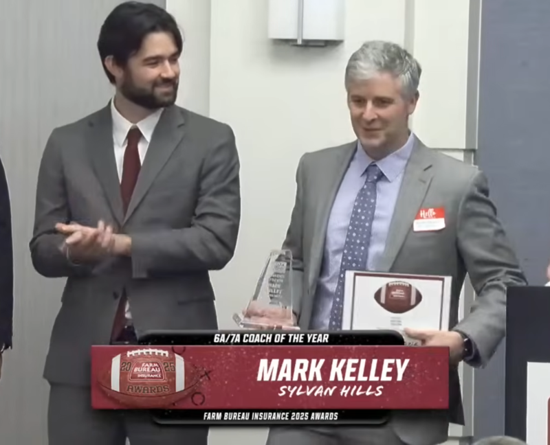 Mark Kelley receiving the 6a/7a coach of the year award