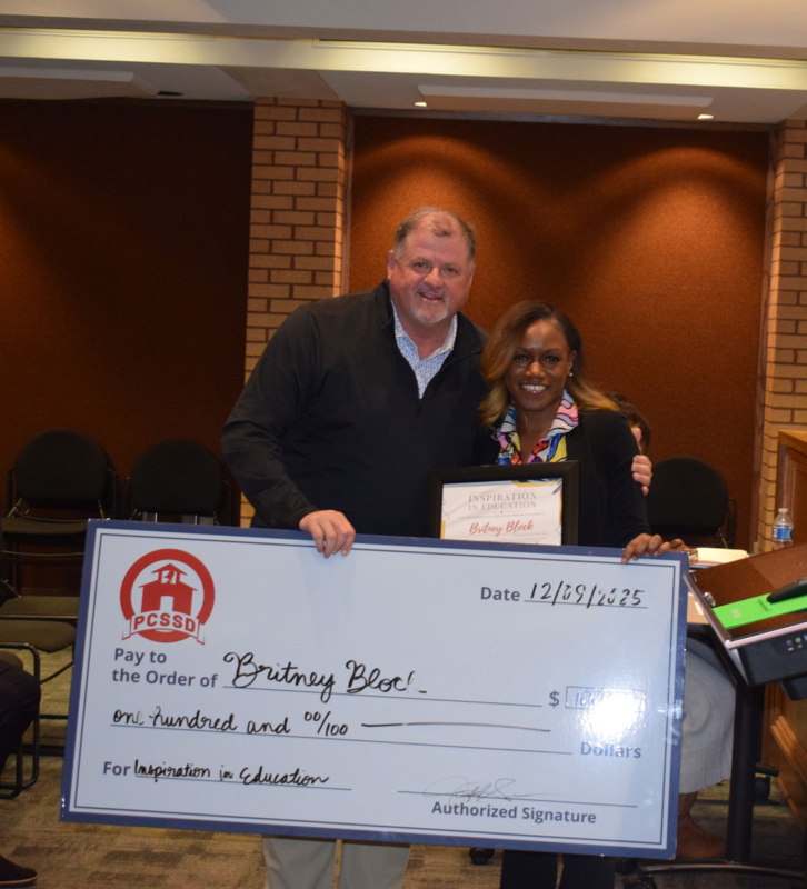 Britney Block with certificate and big check