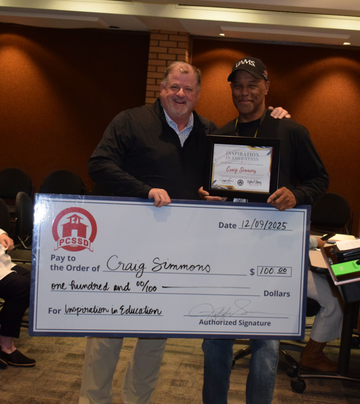 Craig Simmons with award and big check