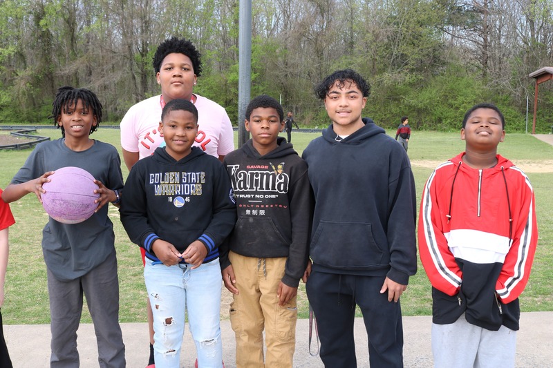 A Sylvan High student poses for a picture with Clinton Elementary students