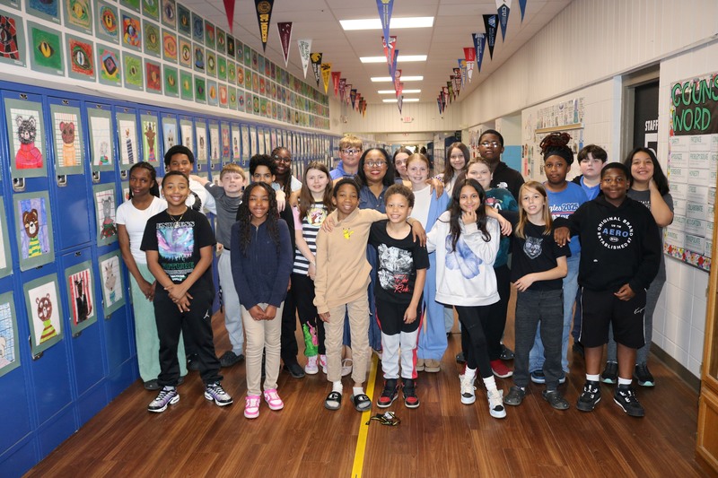 Lillian Hemphill, sixth-grade ELA teacher at Sylvan Hills Middle School, surrounded by her students
