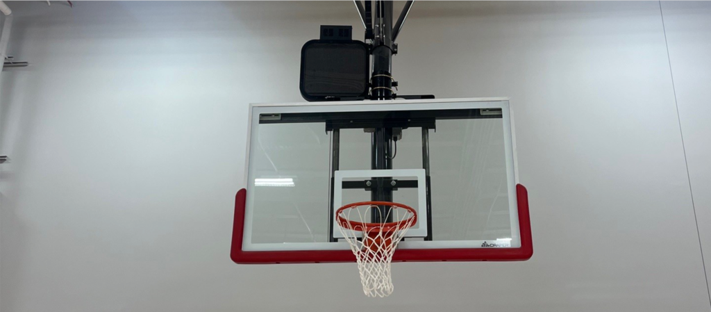 Basketball gola with the shot clock installed on the top section of the goal.
