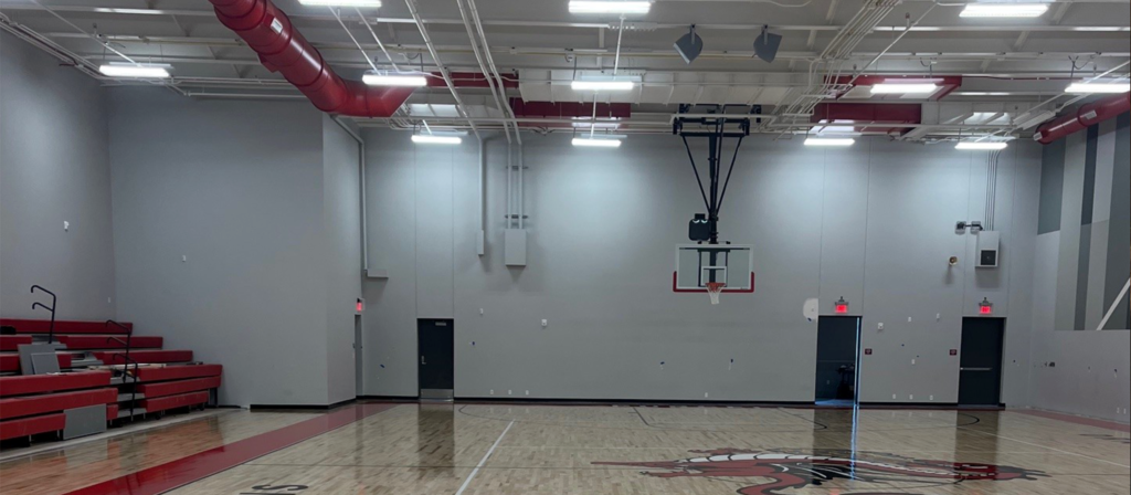 Wide shot of Junior Gym that shows bleachers and floor.