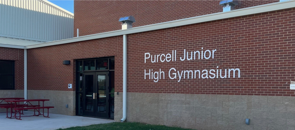 JH gym signage on exterior of building.