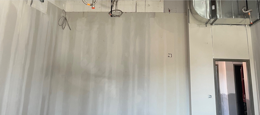 Elementary saferoom walls that have been taped and mudded.