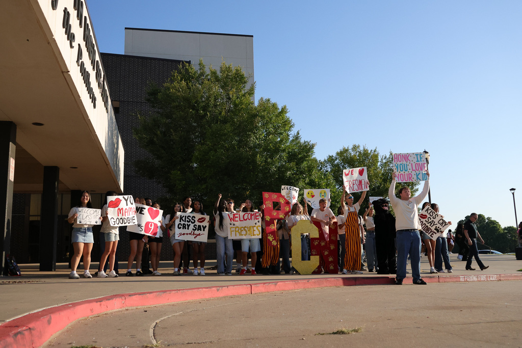 a group of students holding signs