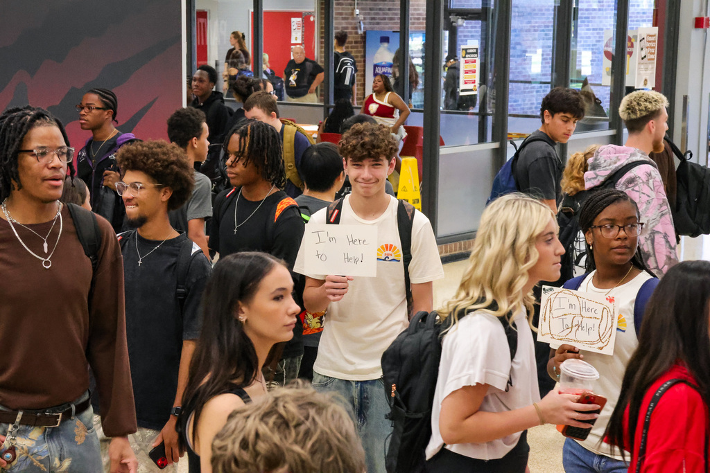 a student holding a sign in a crowd