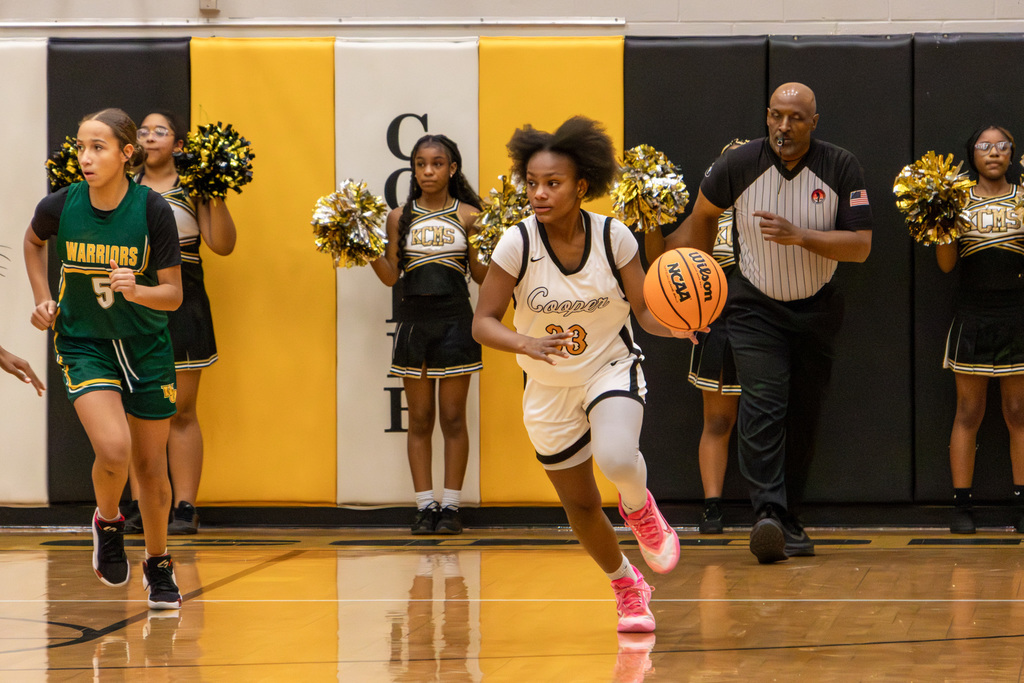 Cooper player dribbling down court