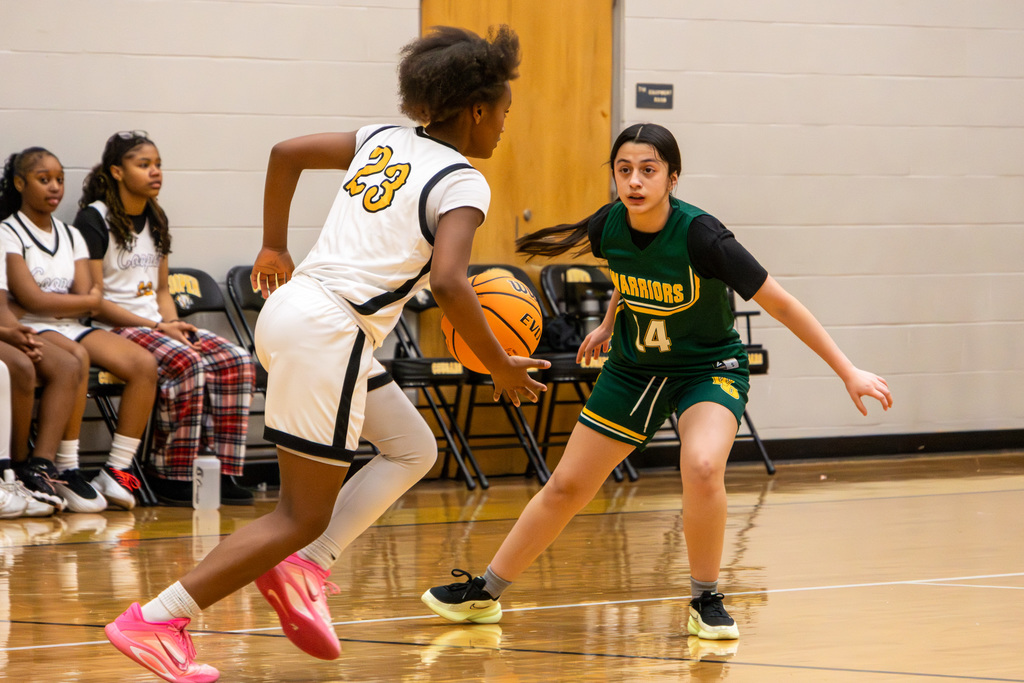 Western Oaks player defending against advancing Cooper player