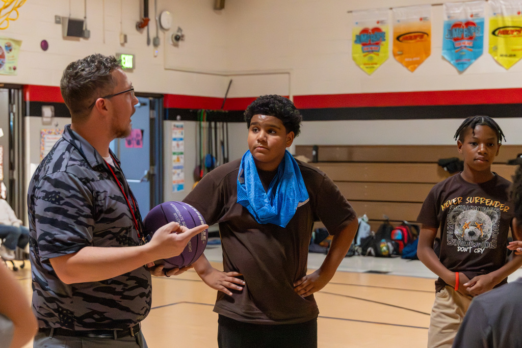 Student stands and listens to coach