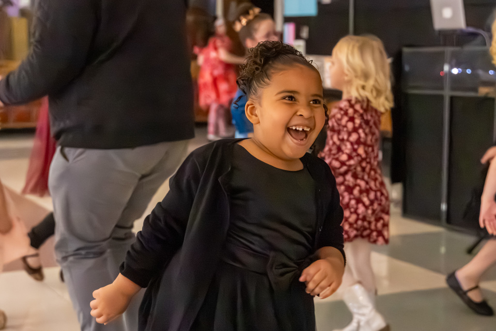 A smiling girl looks up joyfully