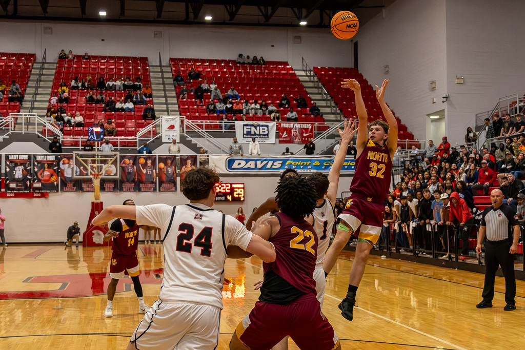 PCN Boys Basketball player shoots a three-pointer during the semi-final round