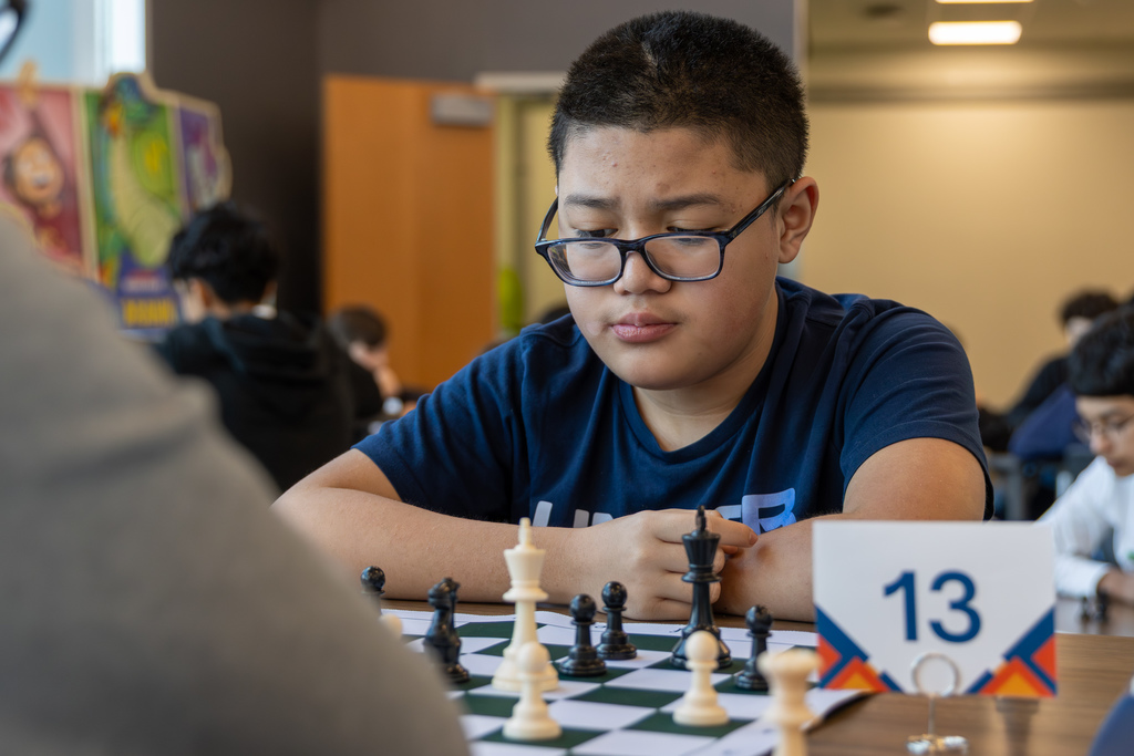 Boy studying chess board